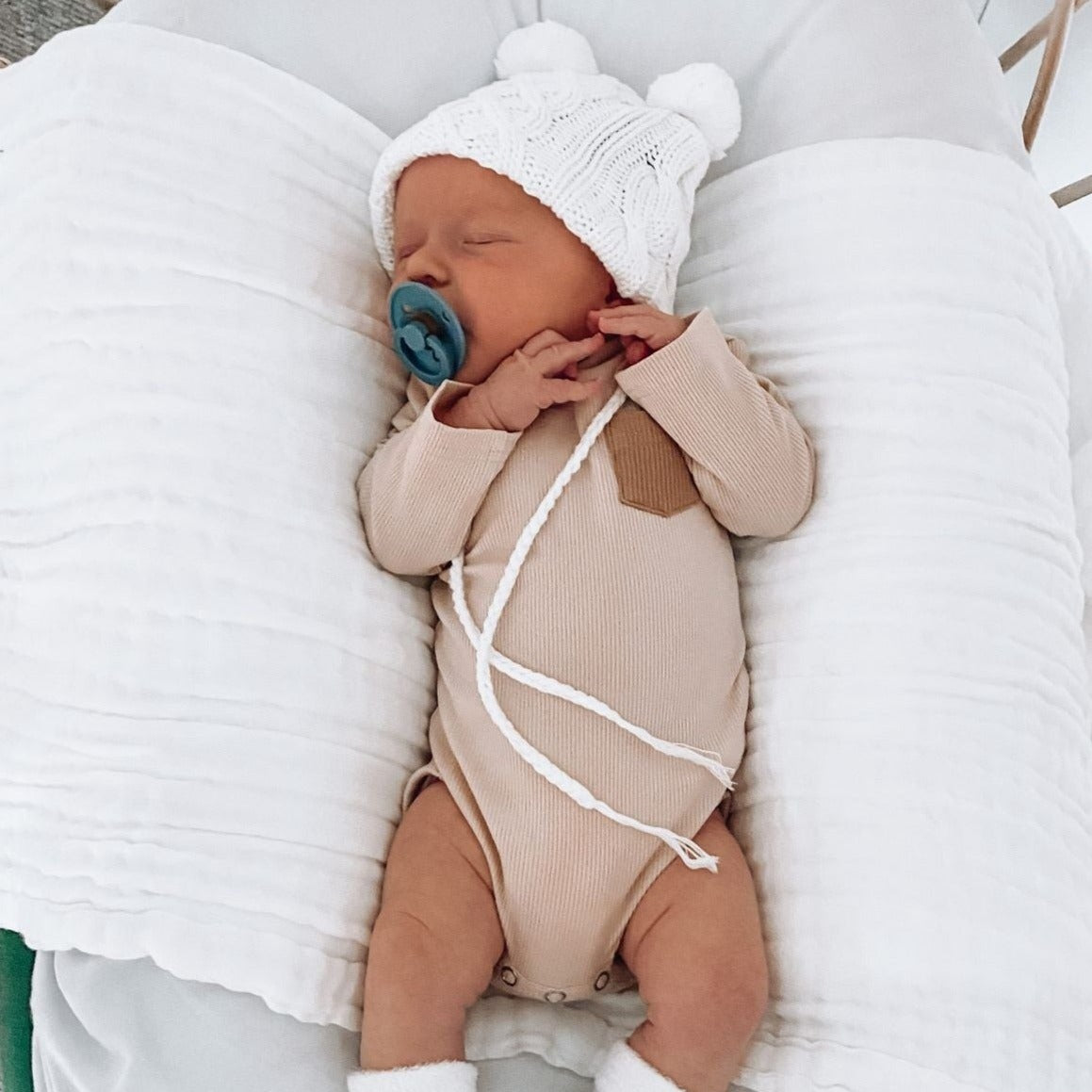 Long sleeve baby onesie, ribbed cotton romper, nuetral nude tone.