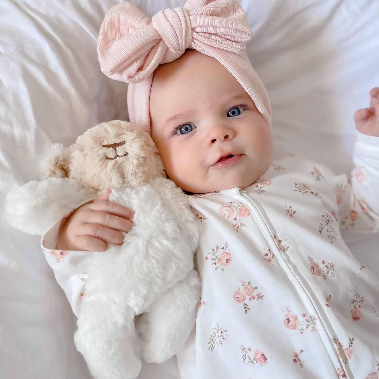 Baby girl, pink topknot, belle sleep suit, lamb teddy