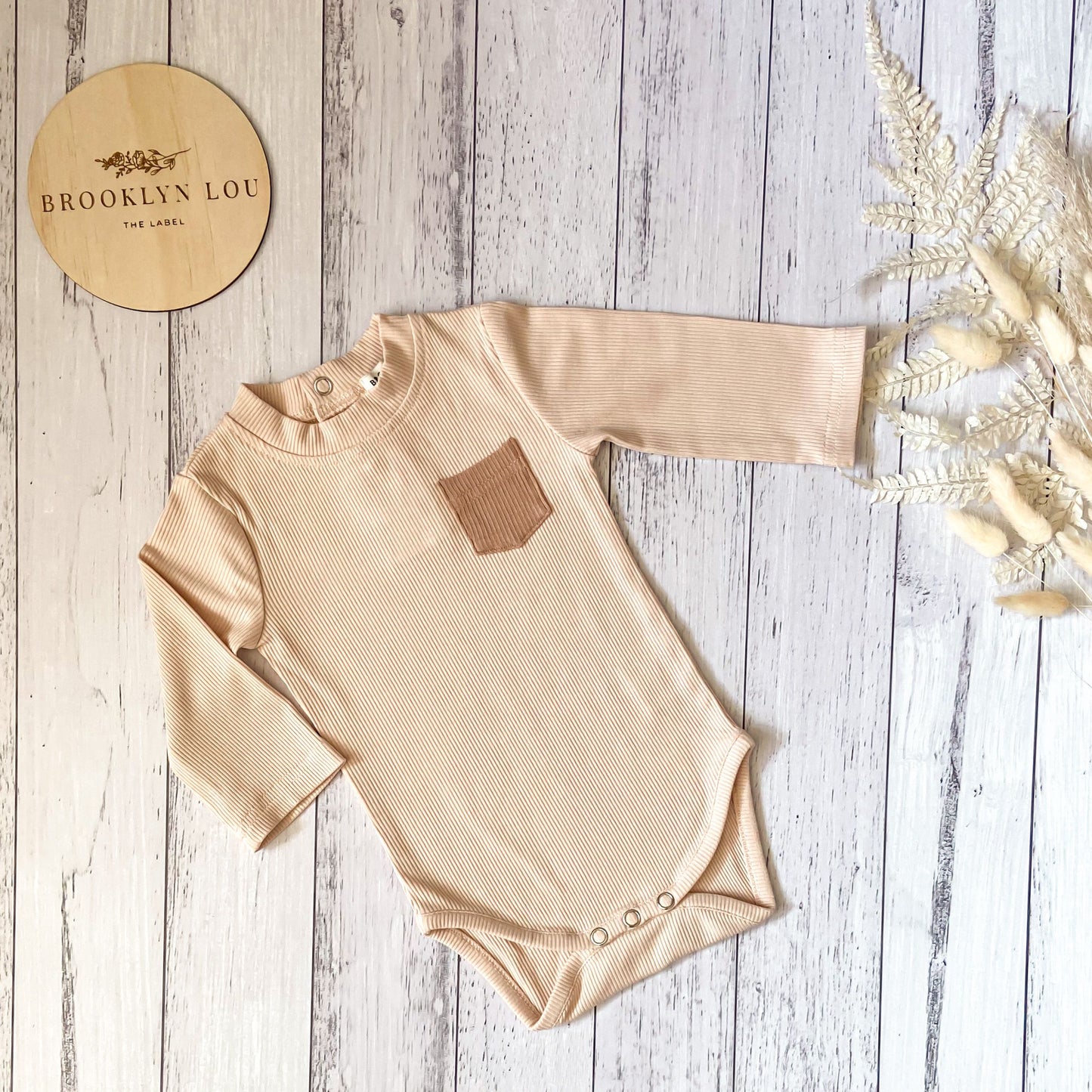 Ribbed cotton nude long sleeve romper. Bodysuit with press studs. Baby romper