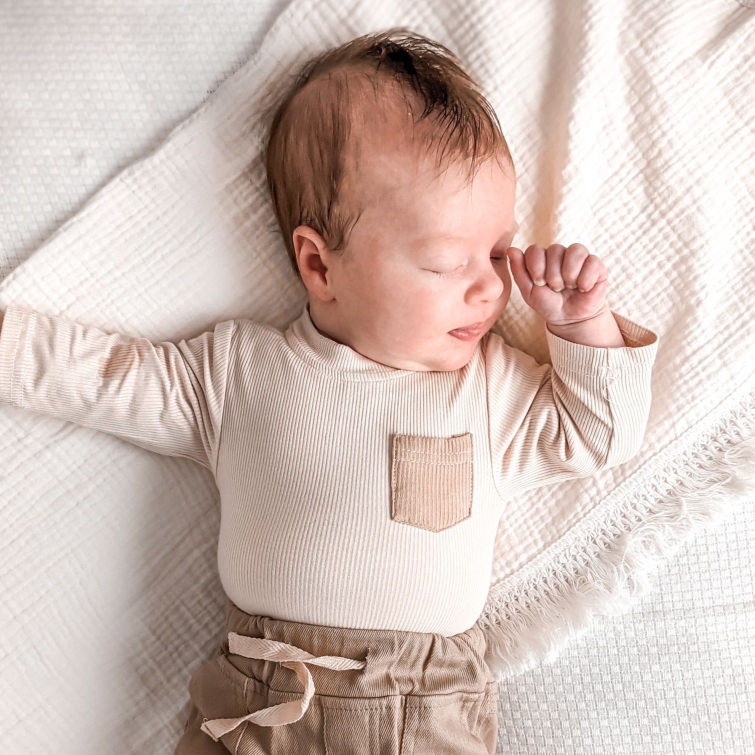 Ribbed cotton nude long sleeve romper. Bodysuit with press studs. Baby romper